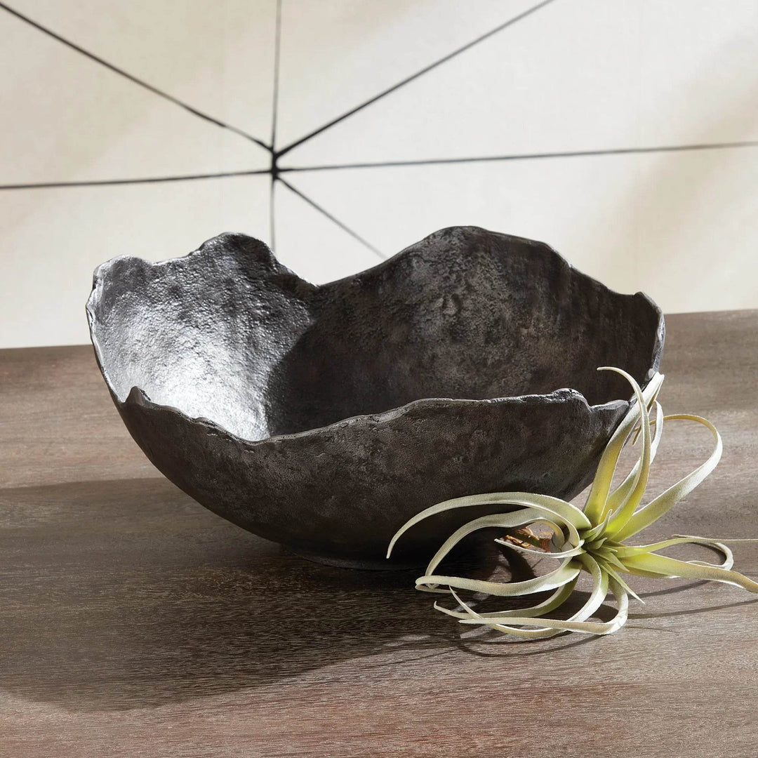 Close-up of black aluminum bowl with textured surface and curved rim, ideal as a large decorative centerpiece for dining tables