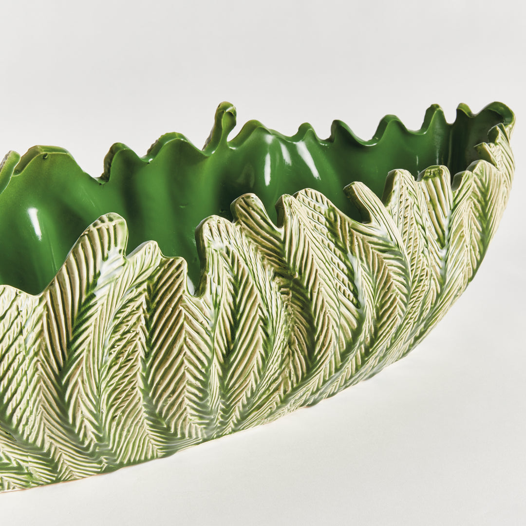 Decorative oval bowl in green with sculpted frond texture elongated clay silhouette artisan centerpiece style