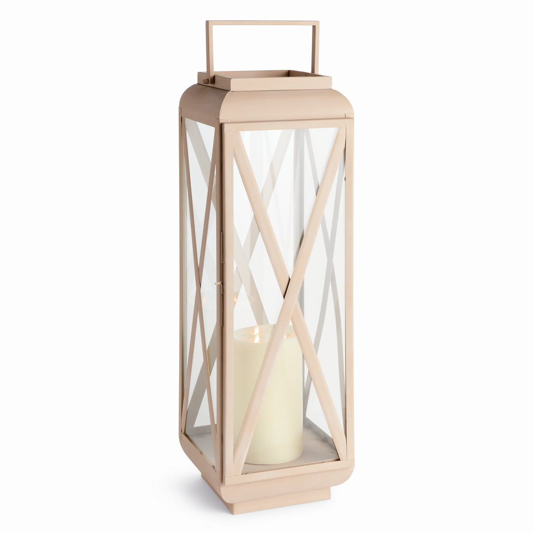Side angle of glass outdoor candle lantern highlighting sandstone-look iron frame and clear glass panels, Modern Organic style