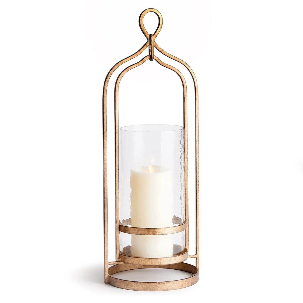 Front view of tall gold hurricane candle holder with hammered glass cylinder and decorative loop handle, iron frame and tray base – Transitional