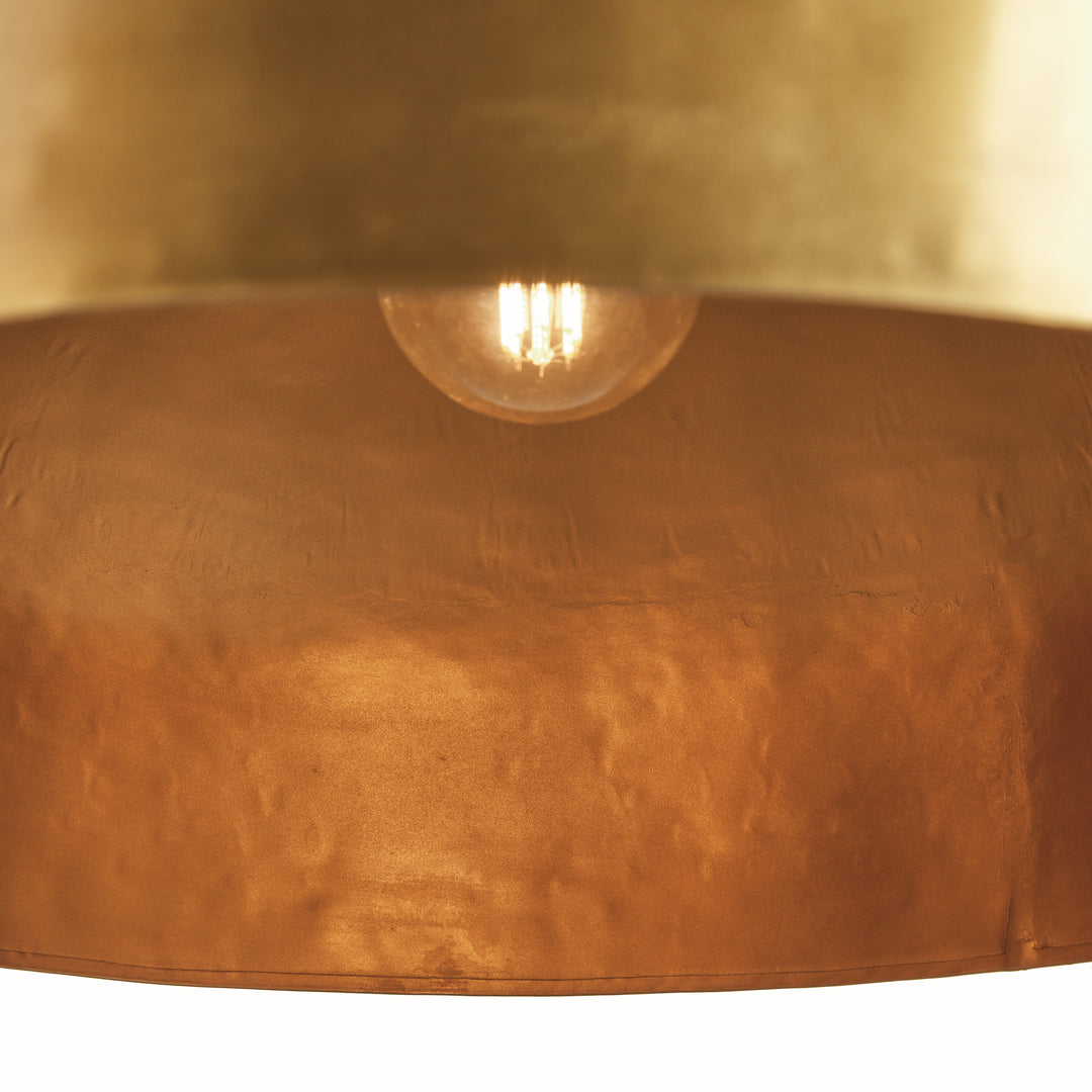 Interior view of large gold iron dome pendant light showing downward light direction, socket placement, and warm metal interior. Contemporary