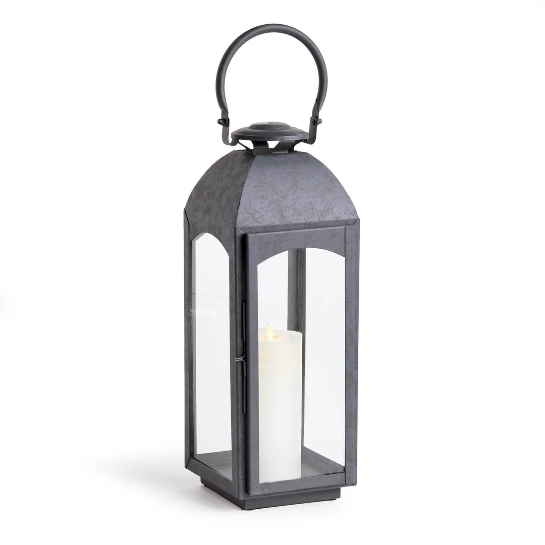 Large gray outdoor lantern with clear glass sides, straight studio view on white with pillar candle centered – Transitional