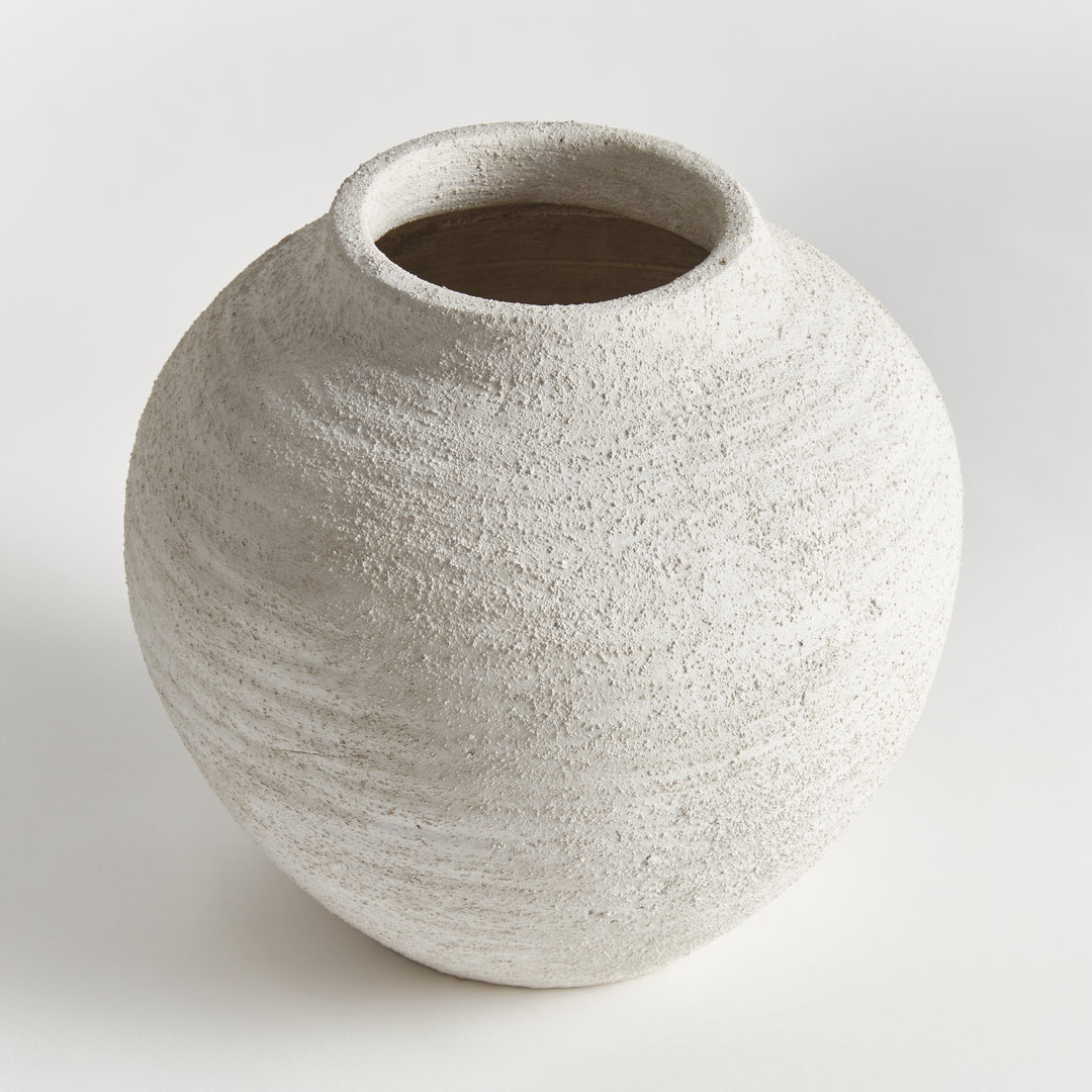 Angled view of large gray terracotta vase with handcrafted textured surface, rounded silhouette and stone-like finish – Transitional