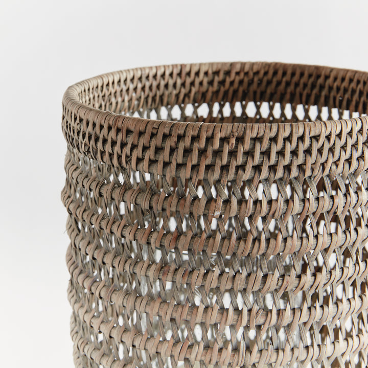 Close view of a large graywash rattan hurricane showing the woven upper rim and open pattern against white, Transitional