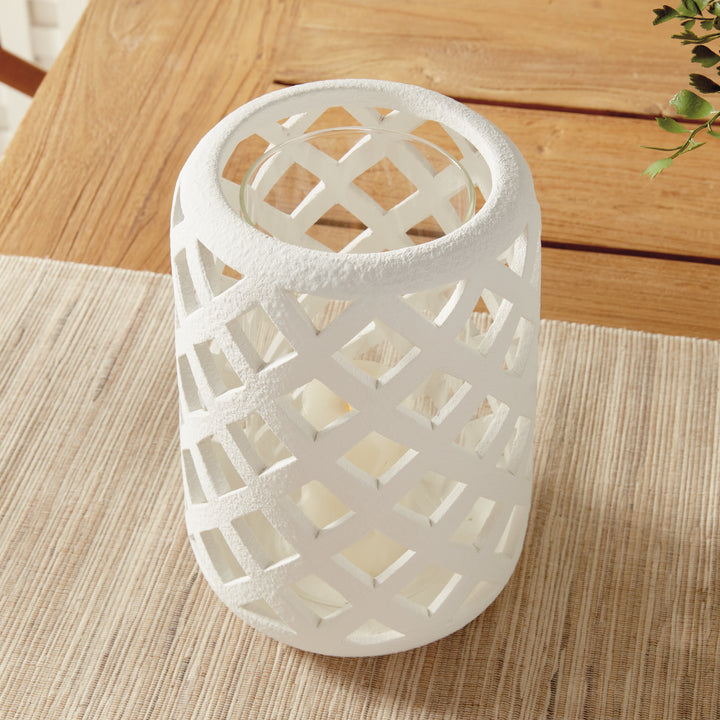 Angled view of large white terracotta hurricane candle holder with lattice cutout design – Coastal Transitional style.