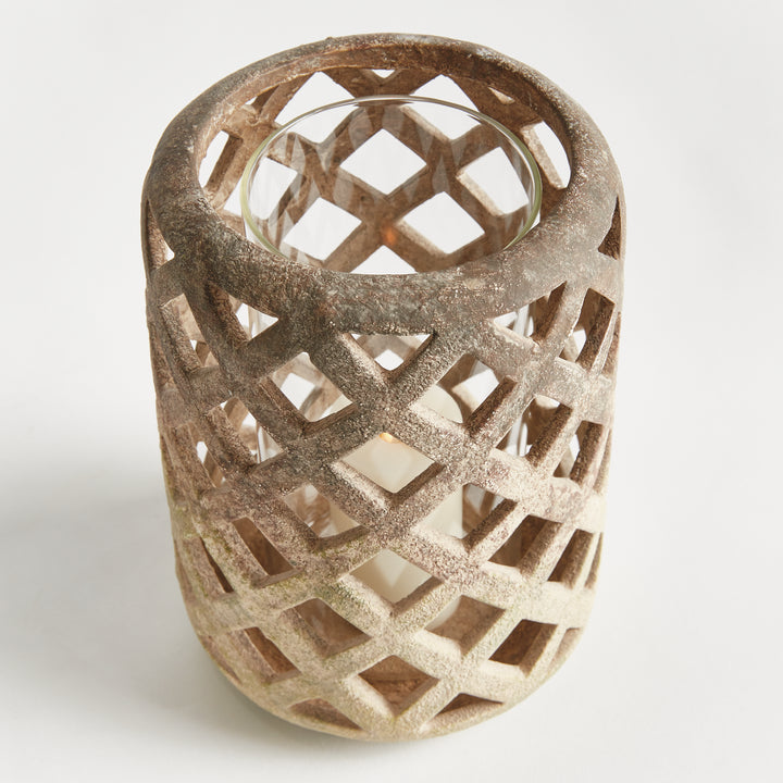 Front angled view of large white terracotta hurricane candle holder with lattice cutouts – Coastal Transitional style.