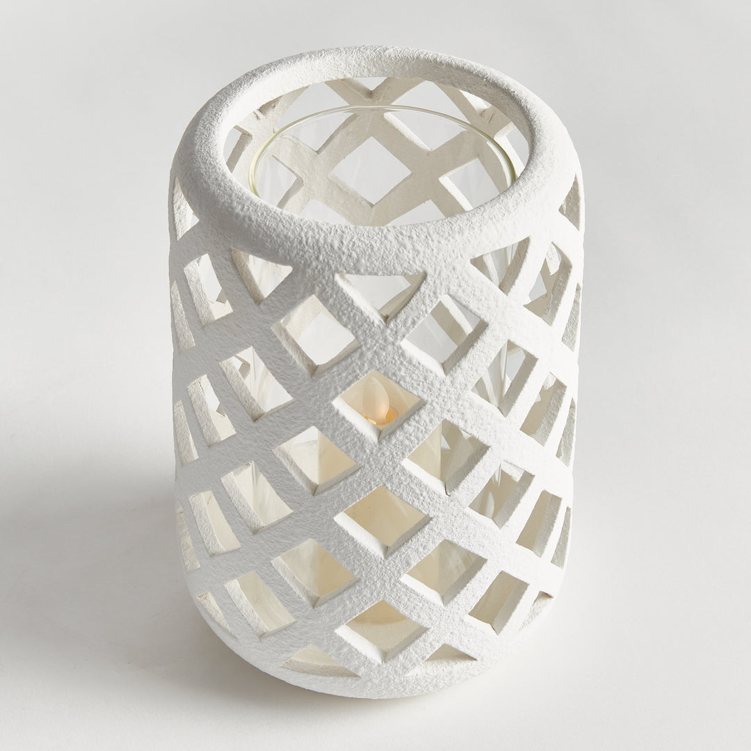 Top view of large white terracotta hurricane candle holder with lattice cutouts and clear glass insert – Coastal Transitional style.