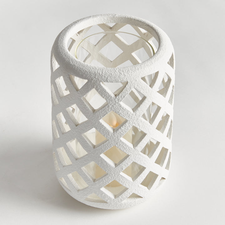 Top view of large white terracotta hurricane candle holder with lattice cutouts and clear glass insert – Coastal Transitional style.