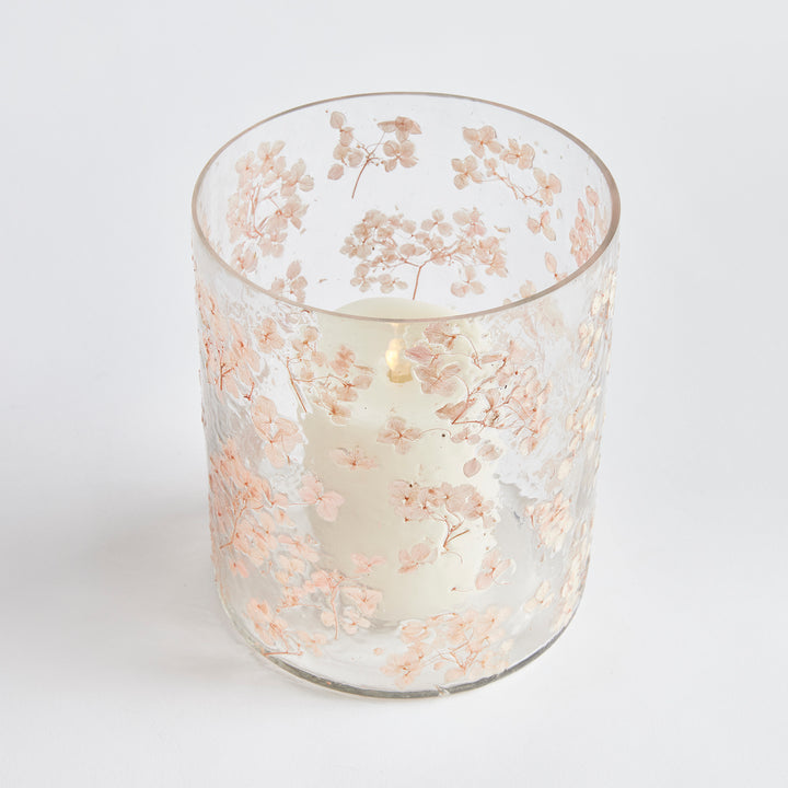 Large clear pink glass hurricane candle holder with preserved flower petals and cylindrical shape, Romantic Transitional