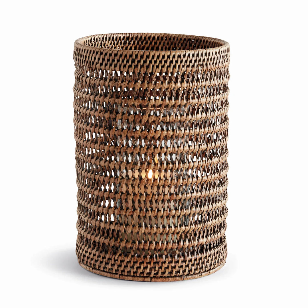 Large warm brown handwoven rattan hurricane candleholder with open cylindrical body and glass insert, on white, Transitional