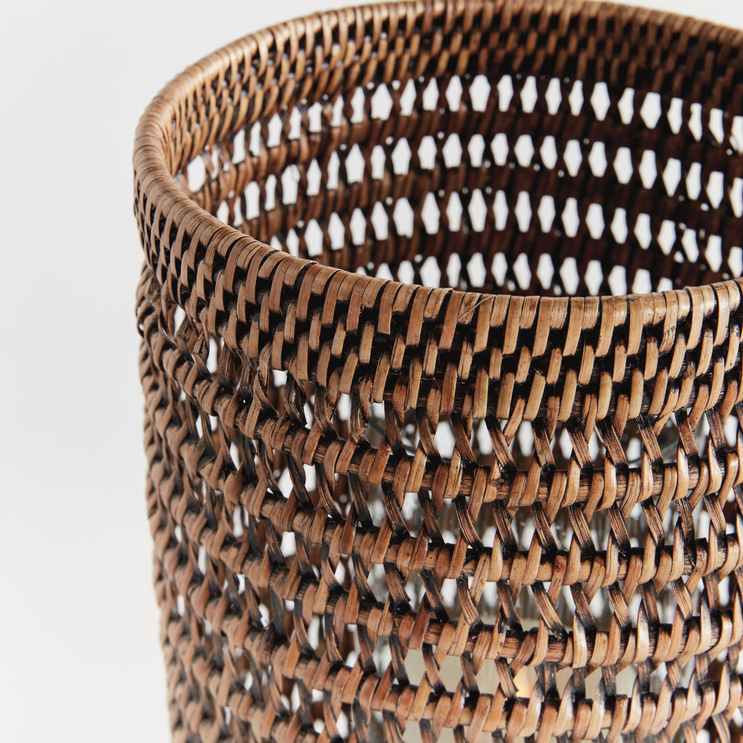 Close view of a large warm brown rattan hurricane showing the woven rim and open geometric pattern on white, Transitional