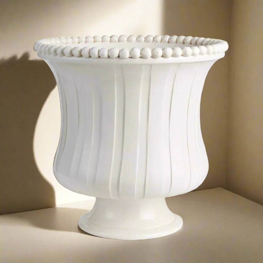 Large white ceramic flared vase with pedestal base, ribbed texture, and beaded rim styled on shelf, handmade in Italy – French Country.

