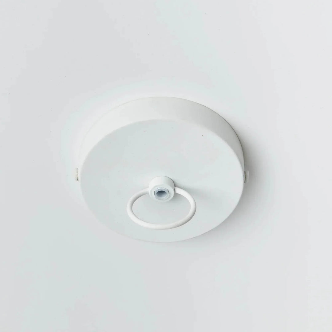 Large white pendant ceiling canopy with a central loop on a round painted metal plate, viewed against white, Coastal style