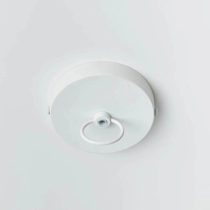 Large white pendant ceiling canopy with a central loop on a round painted metal plate, viewed against white, Coastal style