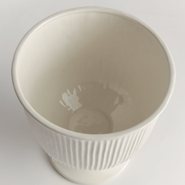 Overhead view into a large white ceramic footed cachepot with ribbed sides and a smooth rounded open interior, Traditional