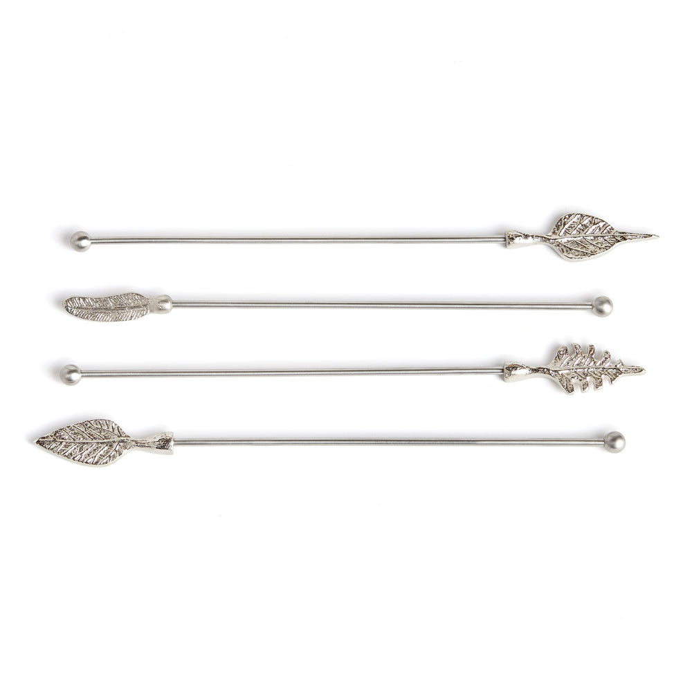 Laurel set of four silver stainless steel swizzle sticks with assorted leaf-shaped tops on a pale background. Transitional