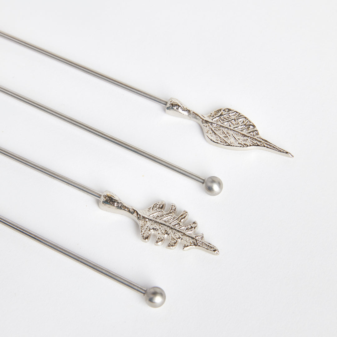 Close view of Laurel silver leaf swizzle sticks showing detailed leaf veins, smooth stems and rounded ends. Transitional