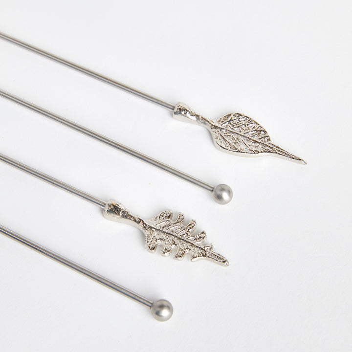 Close view of Laurel silver leaf swizzle sticks showing detailed leaf veins, smooth stems and rounded ends. Transitional