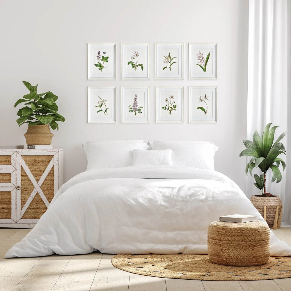 Classic cottage bedroom with lavender botanical wall art set arranged over bed