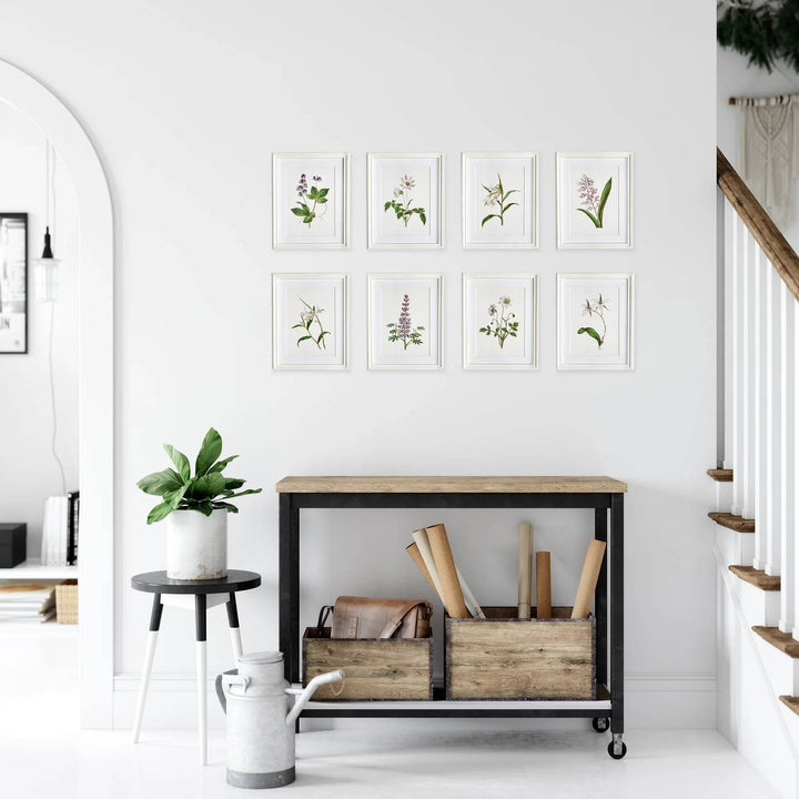 Entryway styled with lavender botanical wall art set in white frames and cottage decor