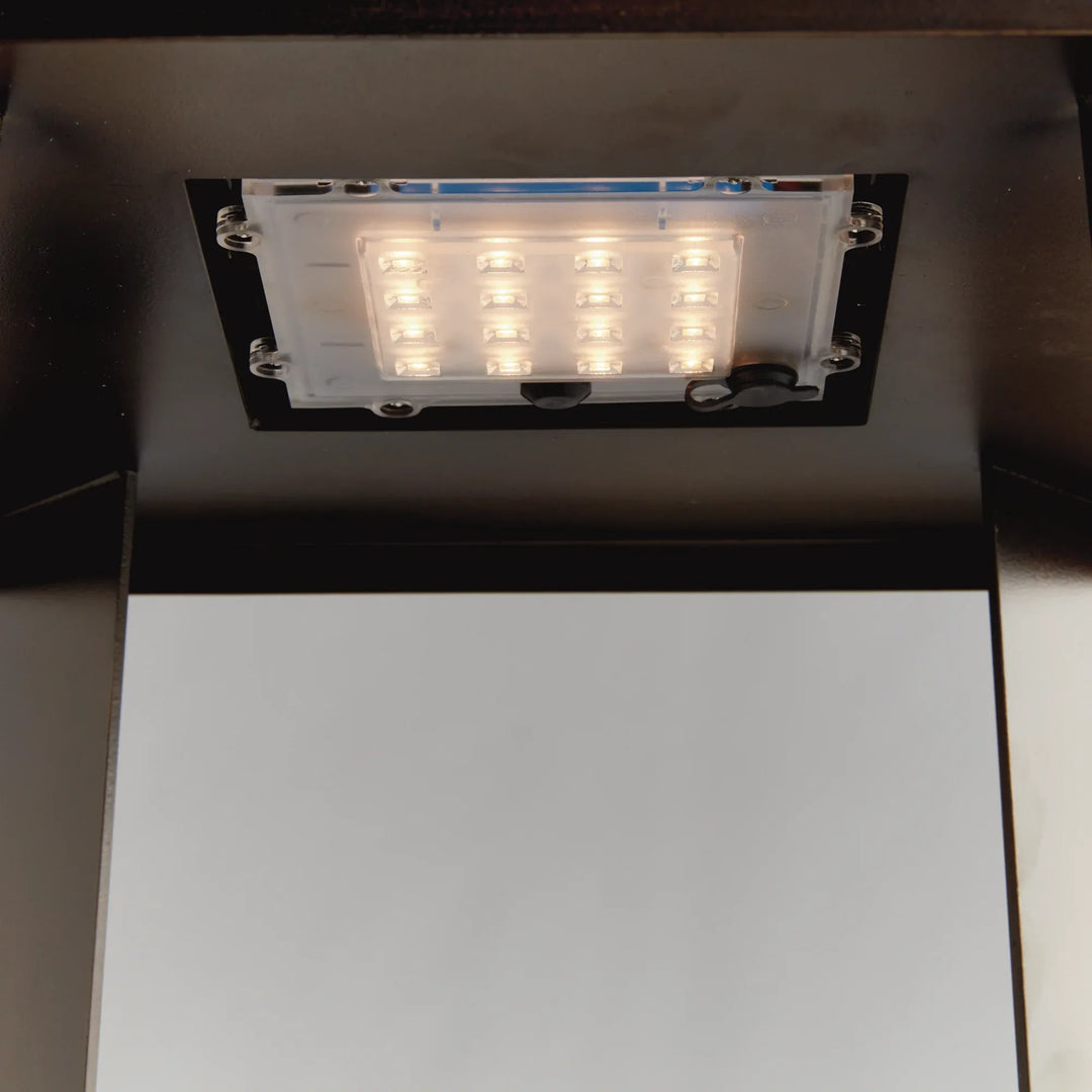 Integrated LED panel underside emitting warm white light, solar-powered lantern detail showing brightness and even illumination