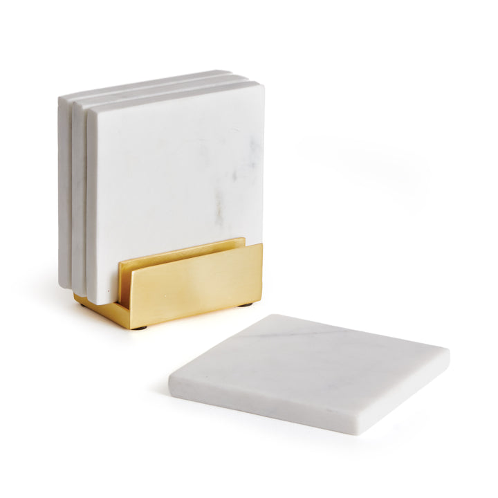 Linden white marble coaster set with four square stone pieces and a gold-tone metal holder on a pale background. Contemporary