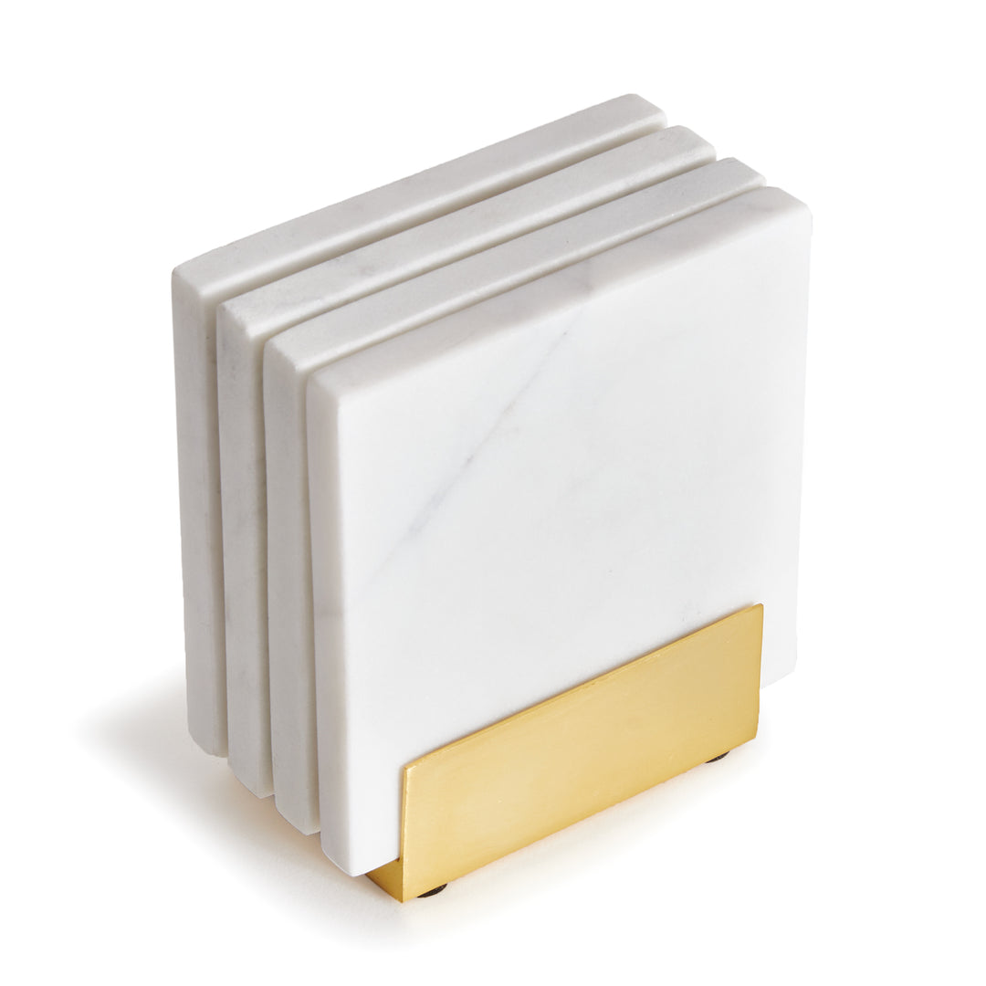 Close view of Linden white marble coasters in a gold-tone holder, showing pale stone veining and square edges. Contemporary