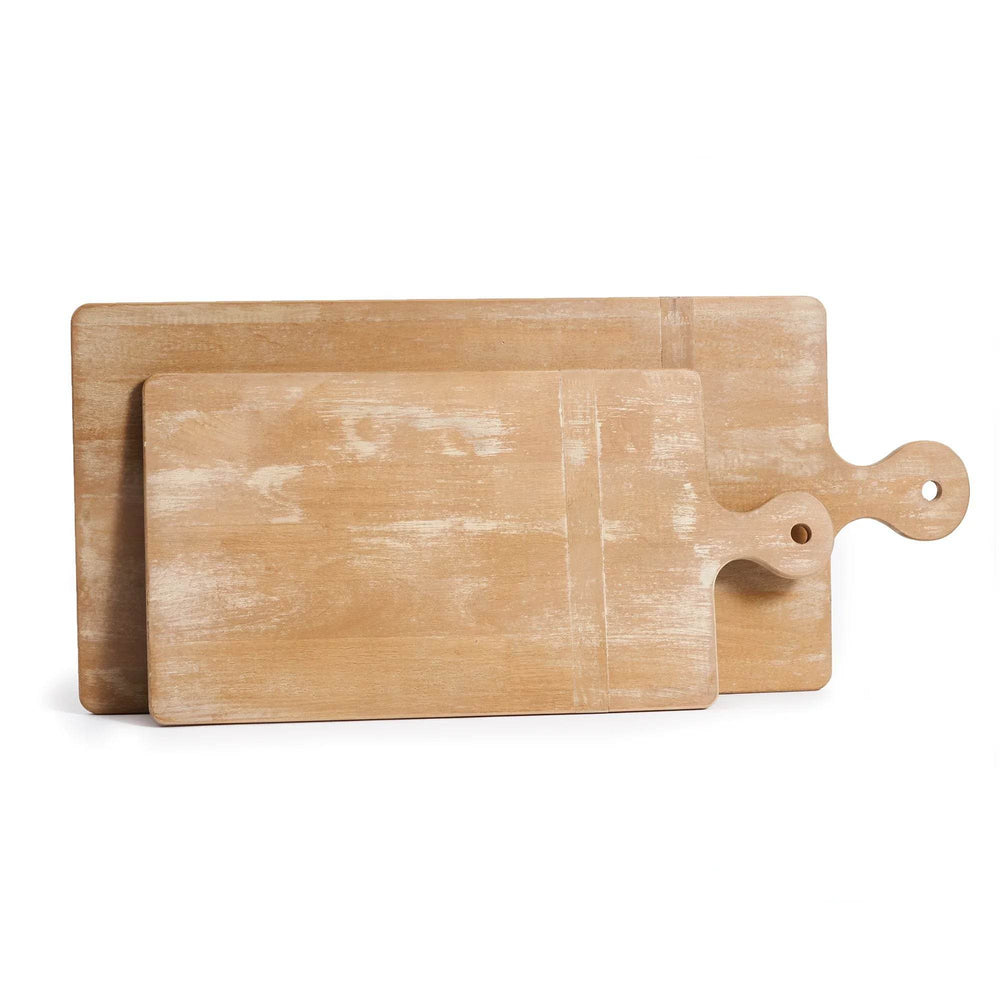 Pair of long wooden cutting boards with handles in whitewash finish, set of two, shown stacked together for functional kitchen or serving use.