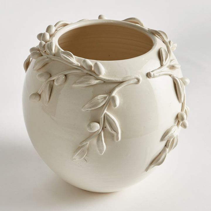 Detailed angled view of a white ceramic olive relief vase, showing a wide opening, rounded body and leaf details. Traditional