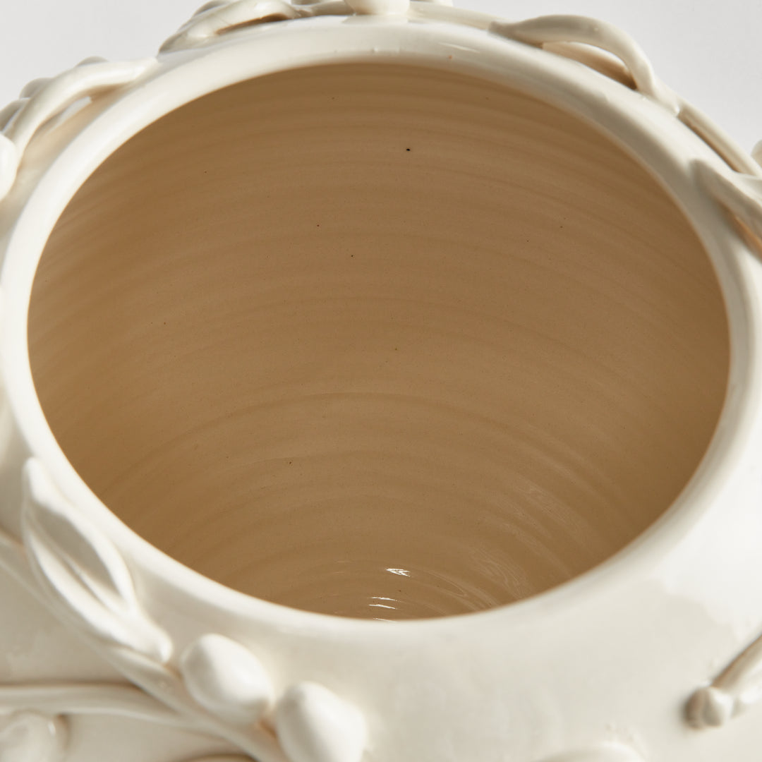 Overhead view inside a ceramic vase showing its unglazed interior, throwing rings and white olive relief rim. Traditional