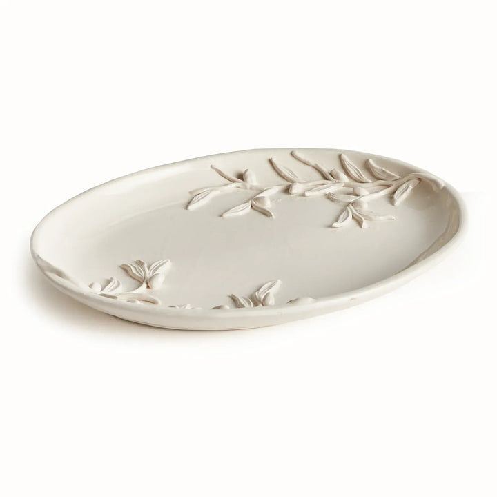 White ceramic tray with an oval outline, shallow rim and raised olive branches across its glazed surface. Classic Traditional