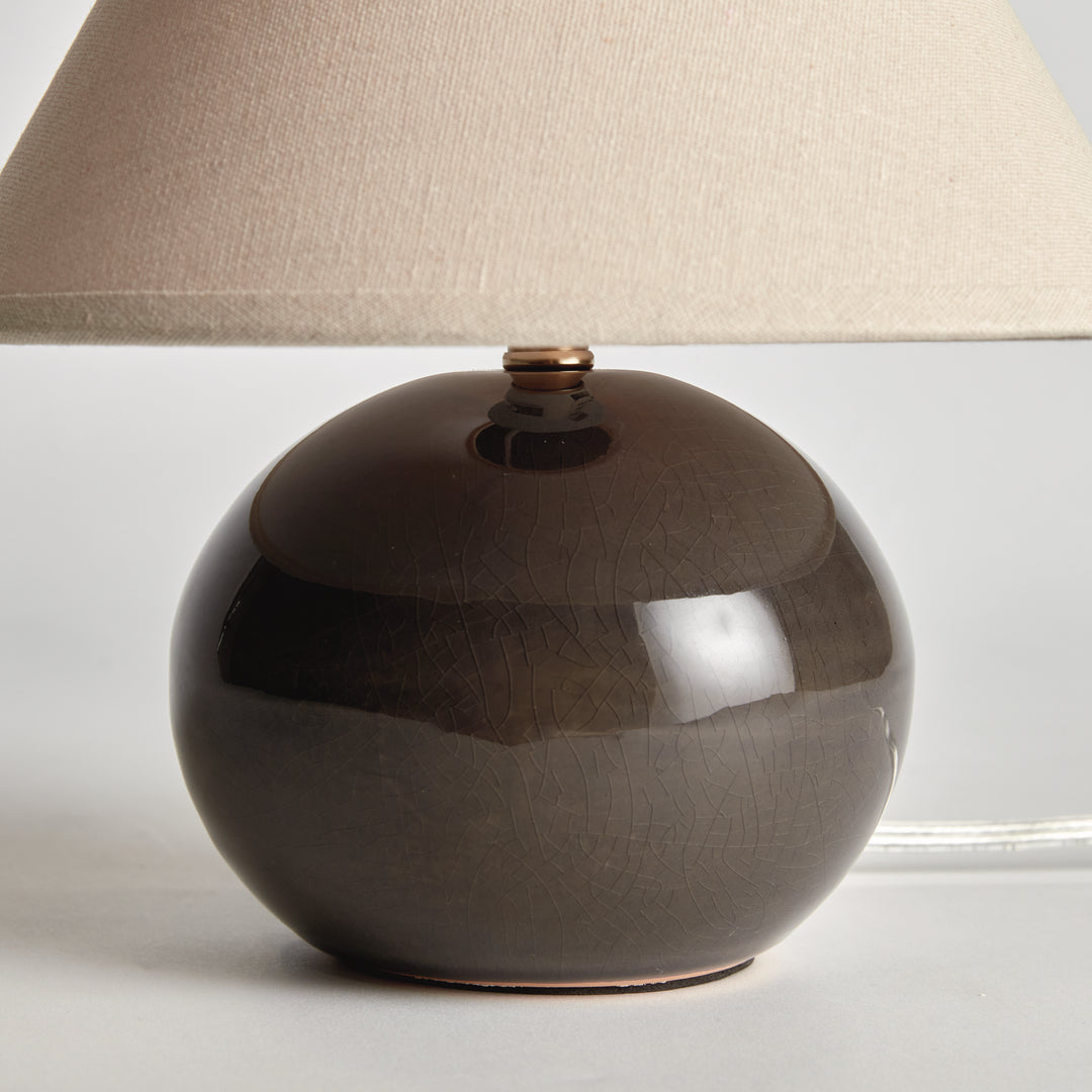 Gray mini ceramic table lamp with linen shade closeup of crackle glaze ceramic base modern accent lighting style