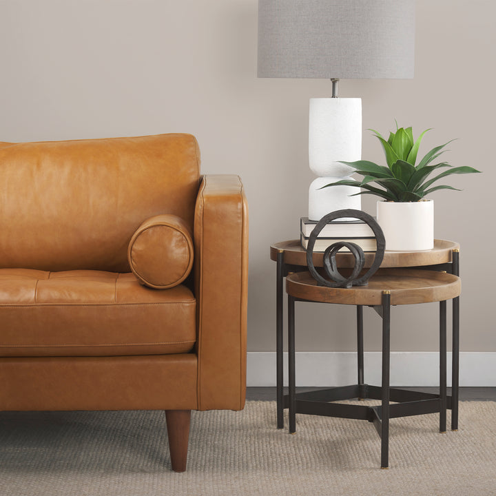Mango wood nesting side tables styled beside a leather sofa with black iron bases and tray tops – Modern Organic