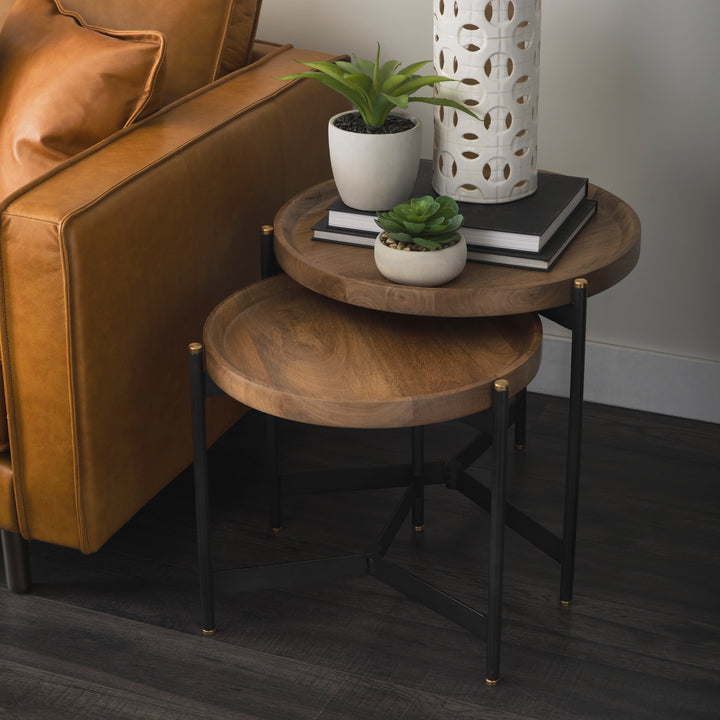 Mango wood nesting side tables styled in a living room beside seating with decorative accents – Modern Organic
