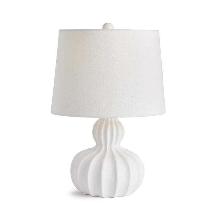 Front view of mango wood table lamp with white sculpted base and linen shade, styled in transitional coastal decor
