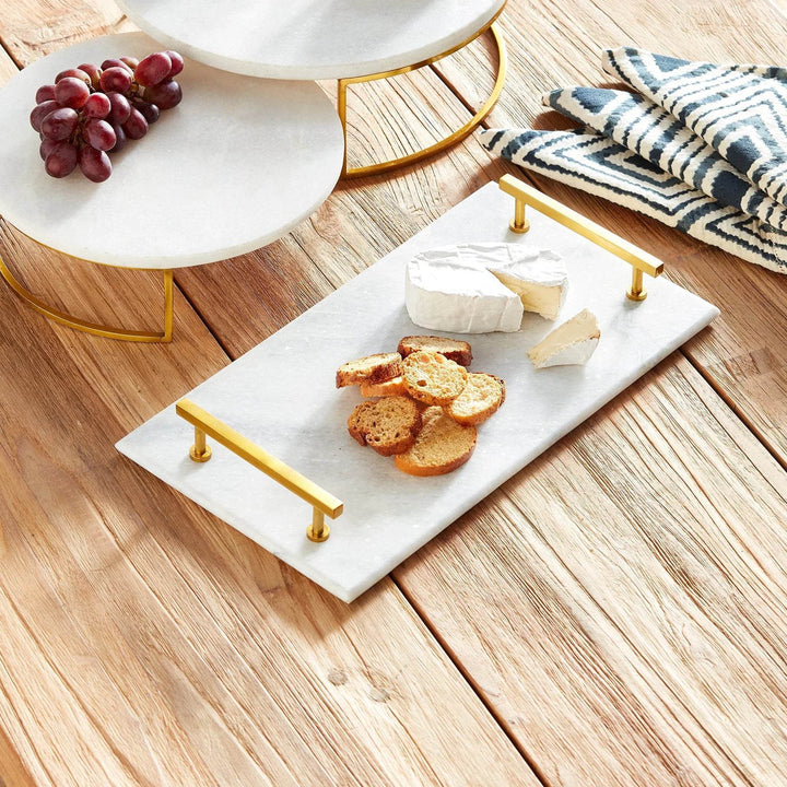 Serving tray with crackers, cheese, and grapes styled on rustic wood table with marble risers – Coastal Glam.

