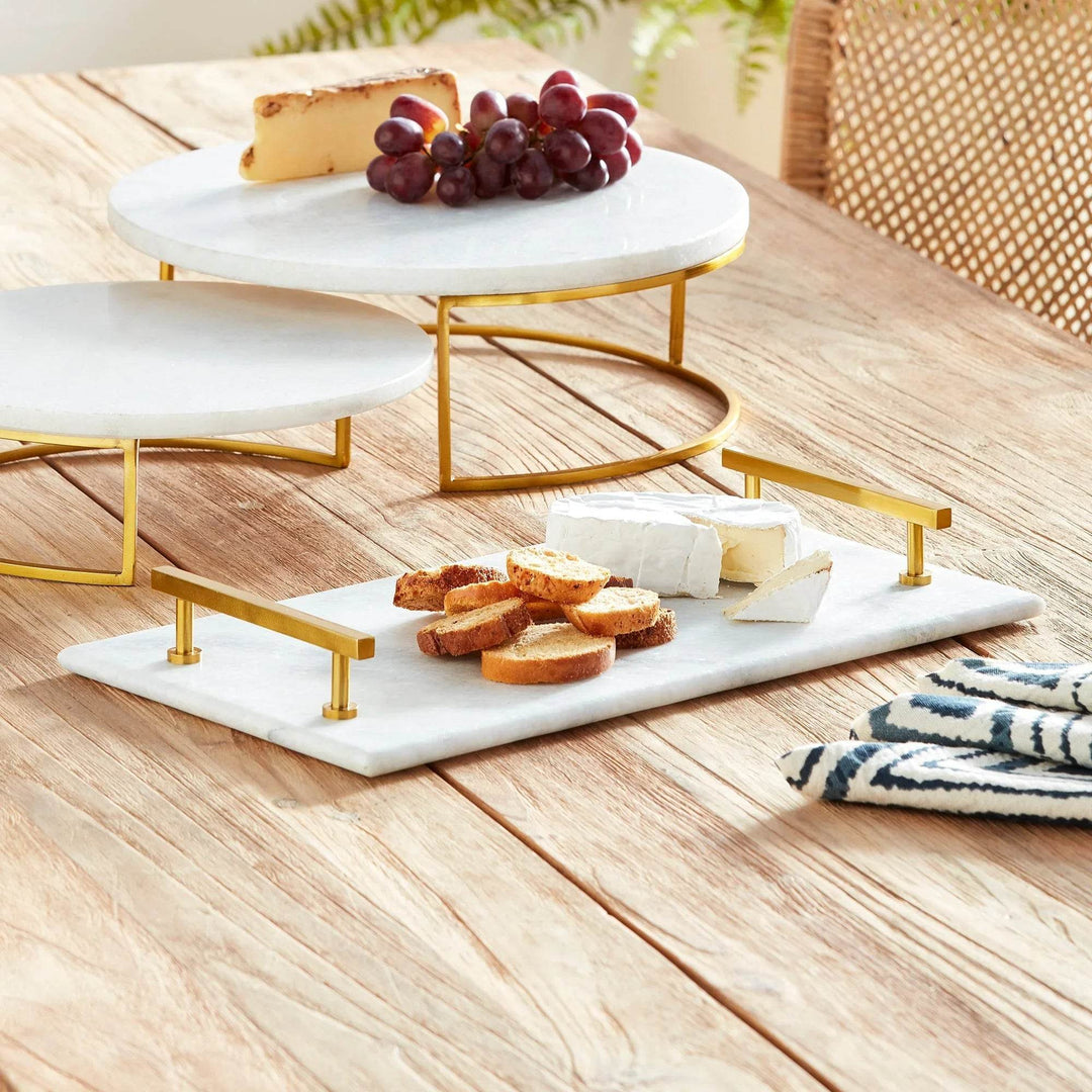 Overhead view of marble serving tray with cheese and bread, part of styled table vignette – Coastal Glam.

