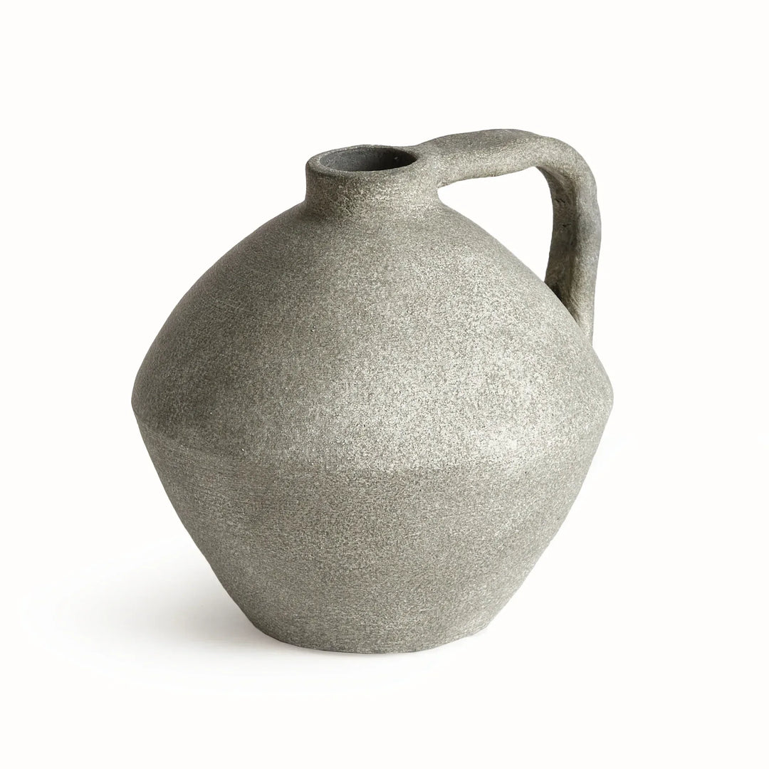 Gray terracotta jug vase with a rounded body, short neck and one curved handle, showing its mottled finish. Modern Organic