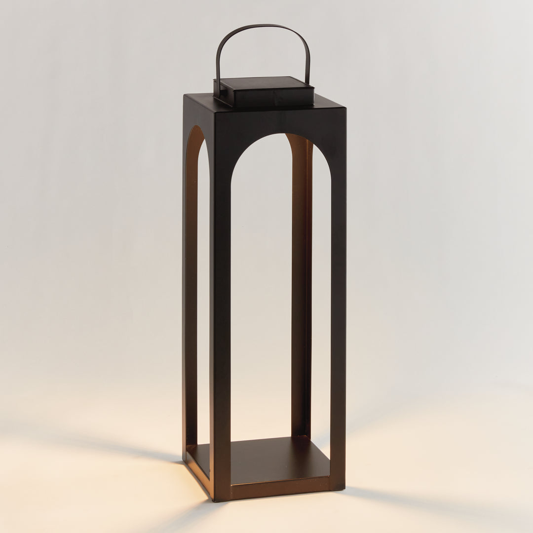 Matte black modern arched solar LED outdoor lantern with powder-coated metal frame and warm 3000K illumination in a 24-inch height – Transitional