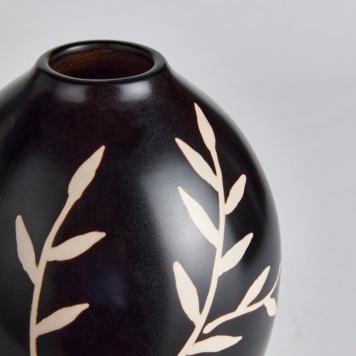 Close-up side angle of etched vine detailing on matte black terracotta vase – Modern Organic.