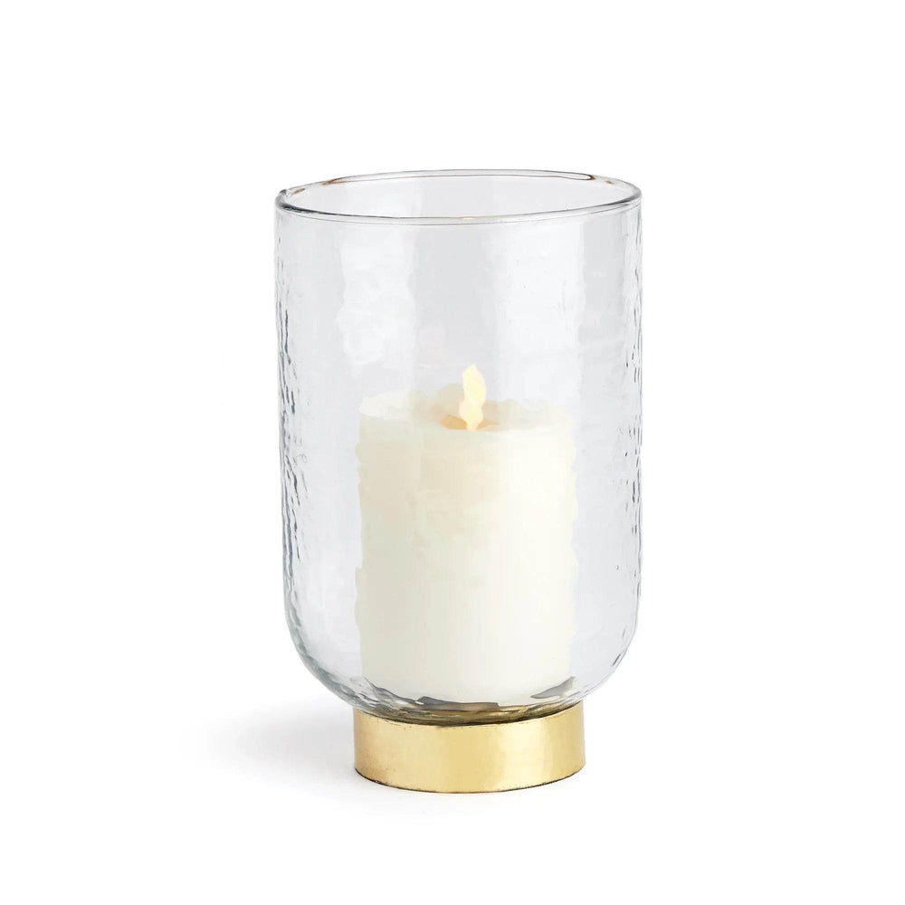 Angled view of medium glass hurricane with hammered clear glass cylinder, gold-tone steel base and pillar candle – Transitional