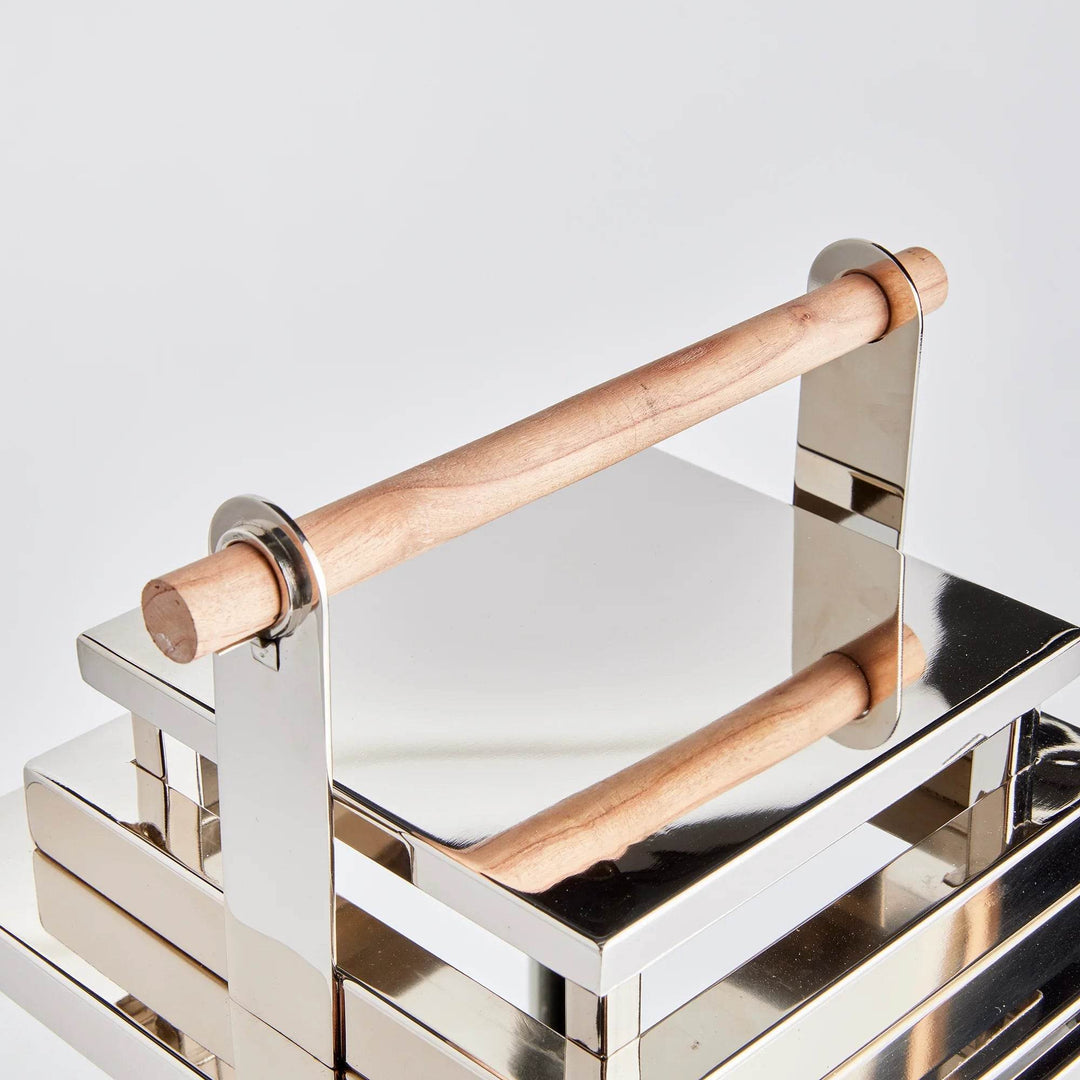 Overhead close-up detail of the teak wood handle and polished silver frame on the lantern
