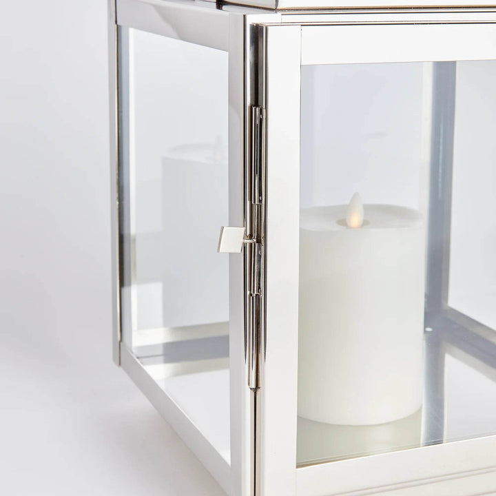 Side view showing glass panels and pillar candle inside the Modern Coastal medium lantern