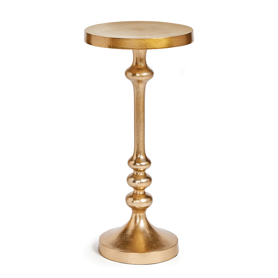 Glam style metal accent table in antique brass finish, 20-inch height with sculptural silhouette.