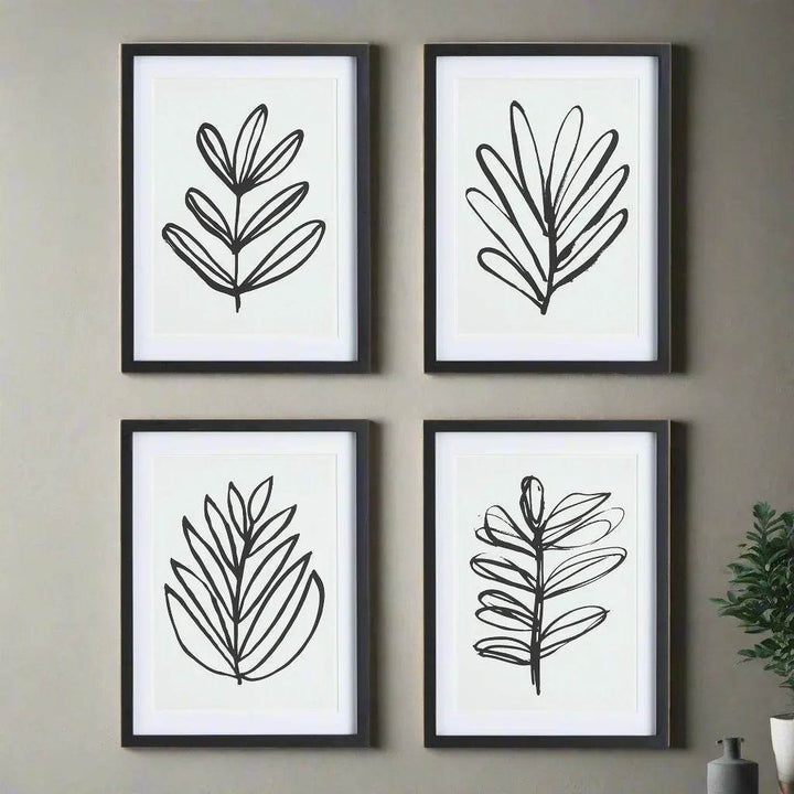 Detail of 4 black and white botanical leaf sketches in black wood frames with mat – modern minimalist styling