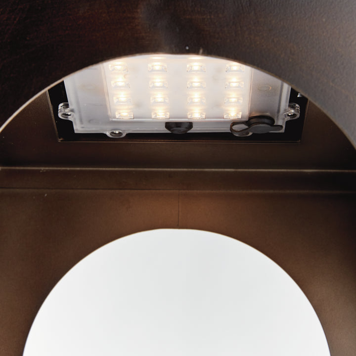 Close-up of the graceful arched opening and powder-coated metal frame on a modern solar LED outdoor lantern – Transitional