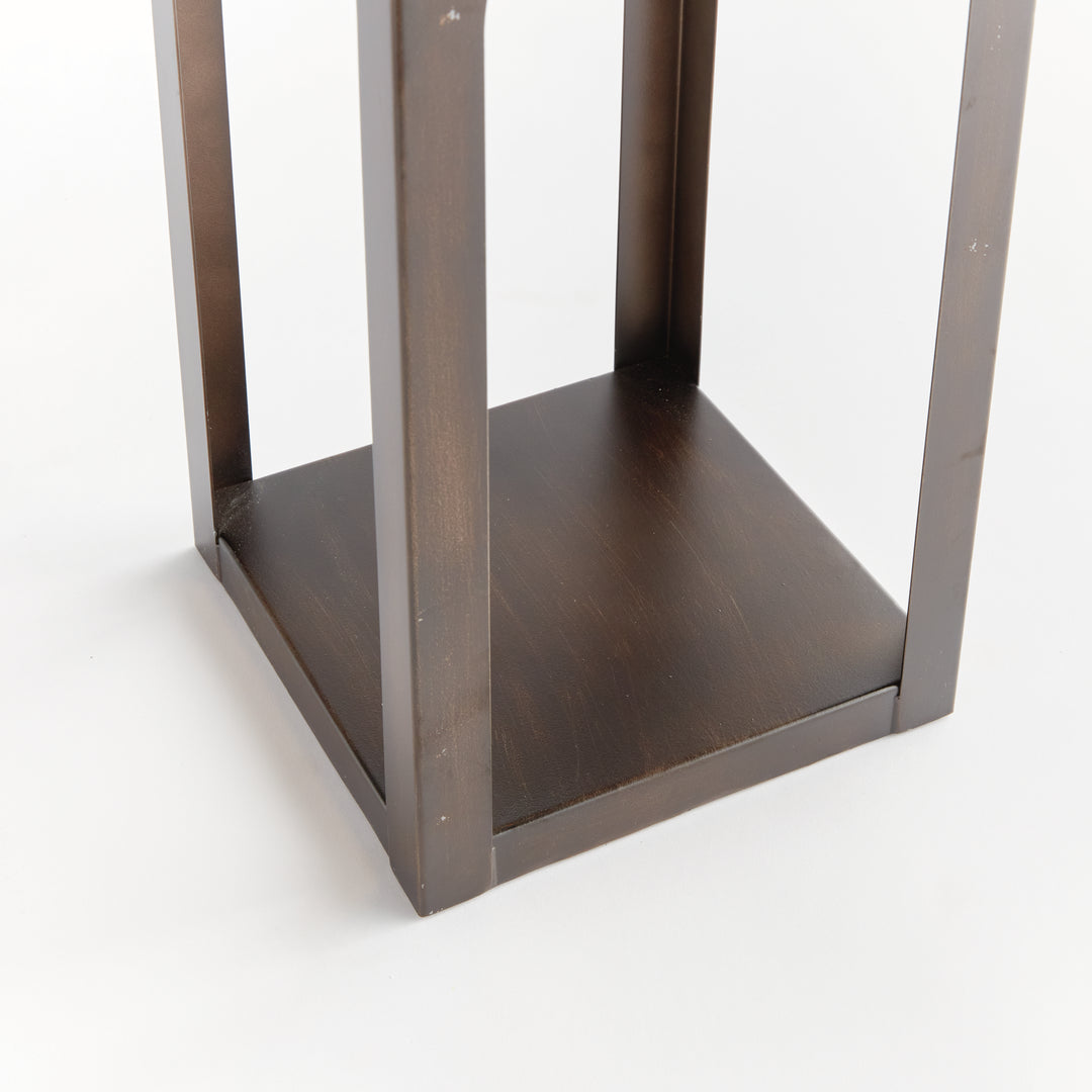 Close-up of the powder-coated metal base on a modern arched solar LED outdoor lantern showing its sturdy architectural construction – Transitional