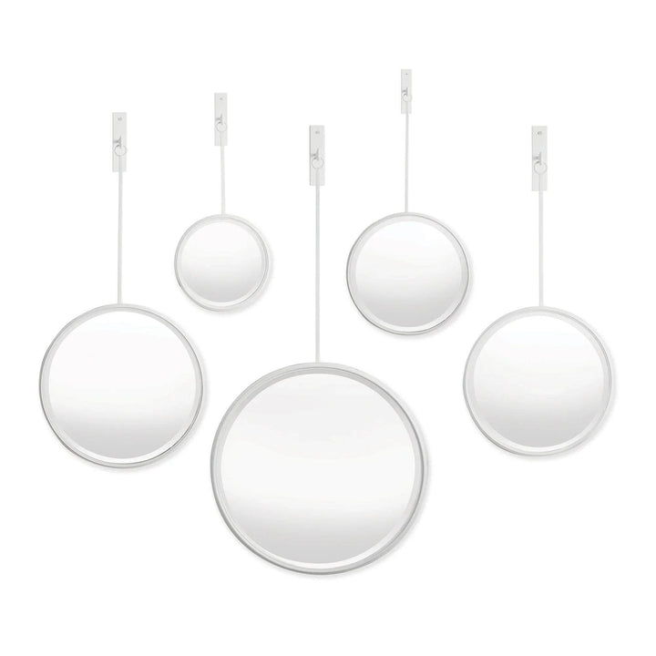 Cluster of five round white-framed wall mirrors with brackets and rods, arranged against a white background