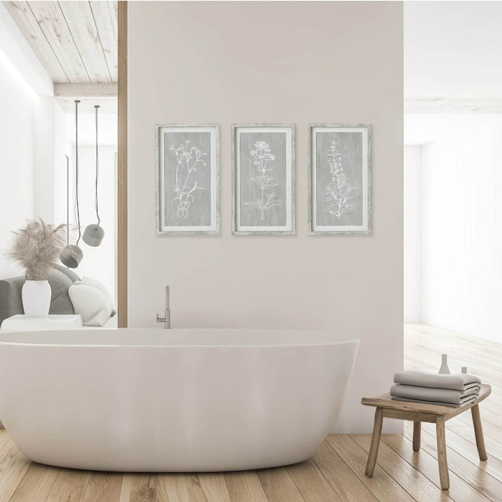 Minimalist bathroom with set of 3 vertical framed botanical prints above tub, modern farmhouse wall styling
