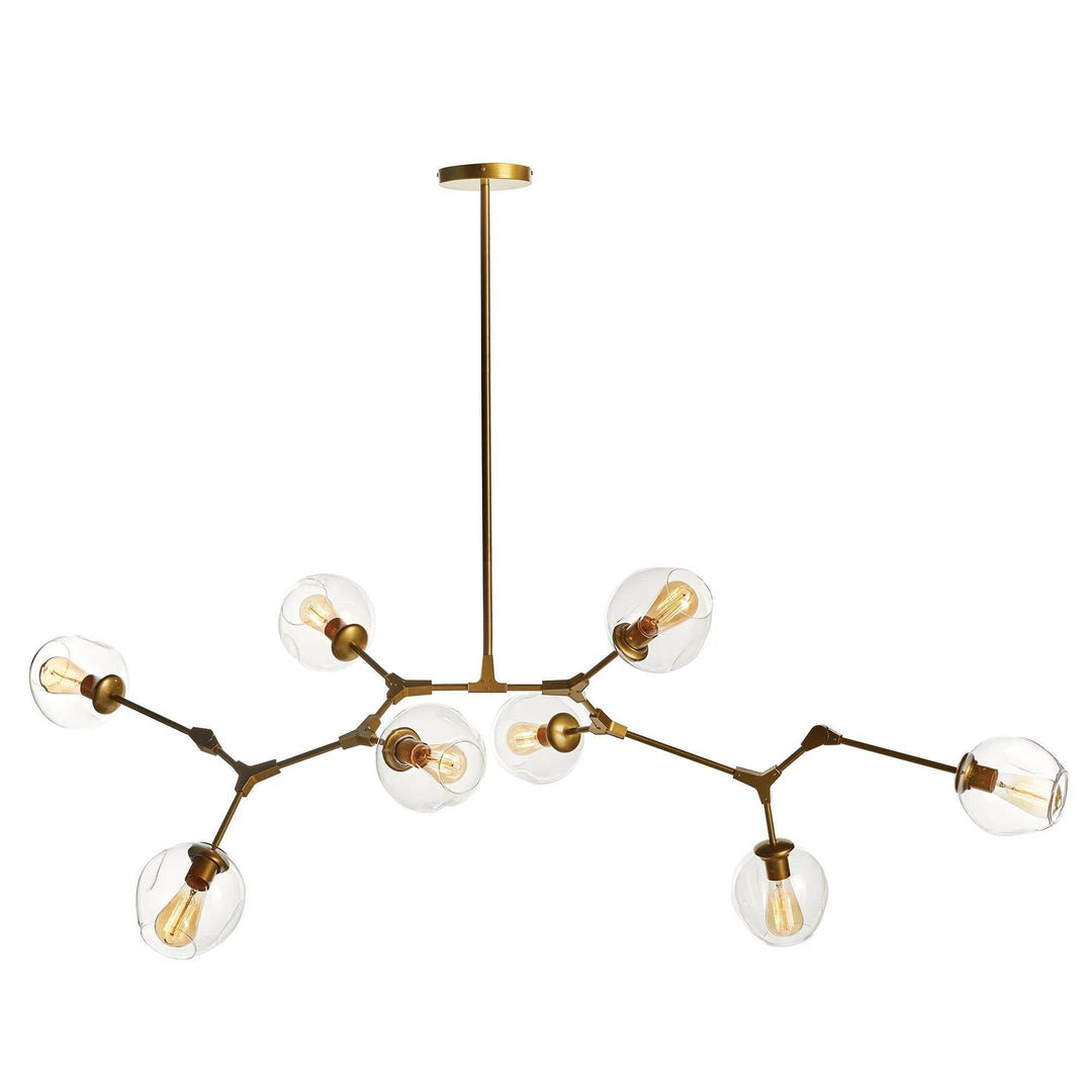 Clean product view of modern brass chandelier with eight clear globes and matte brass finish.